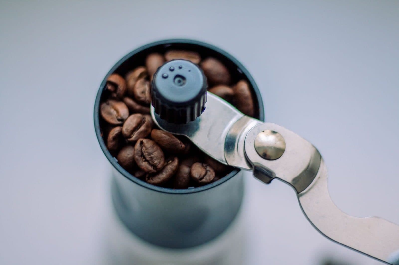 Close-up of a coffee grinder with fresh beans.